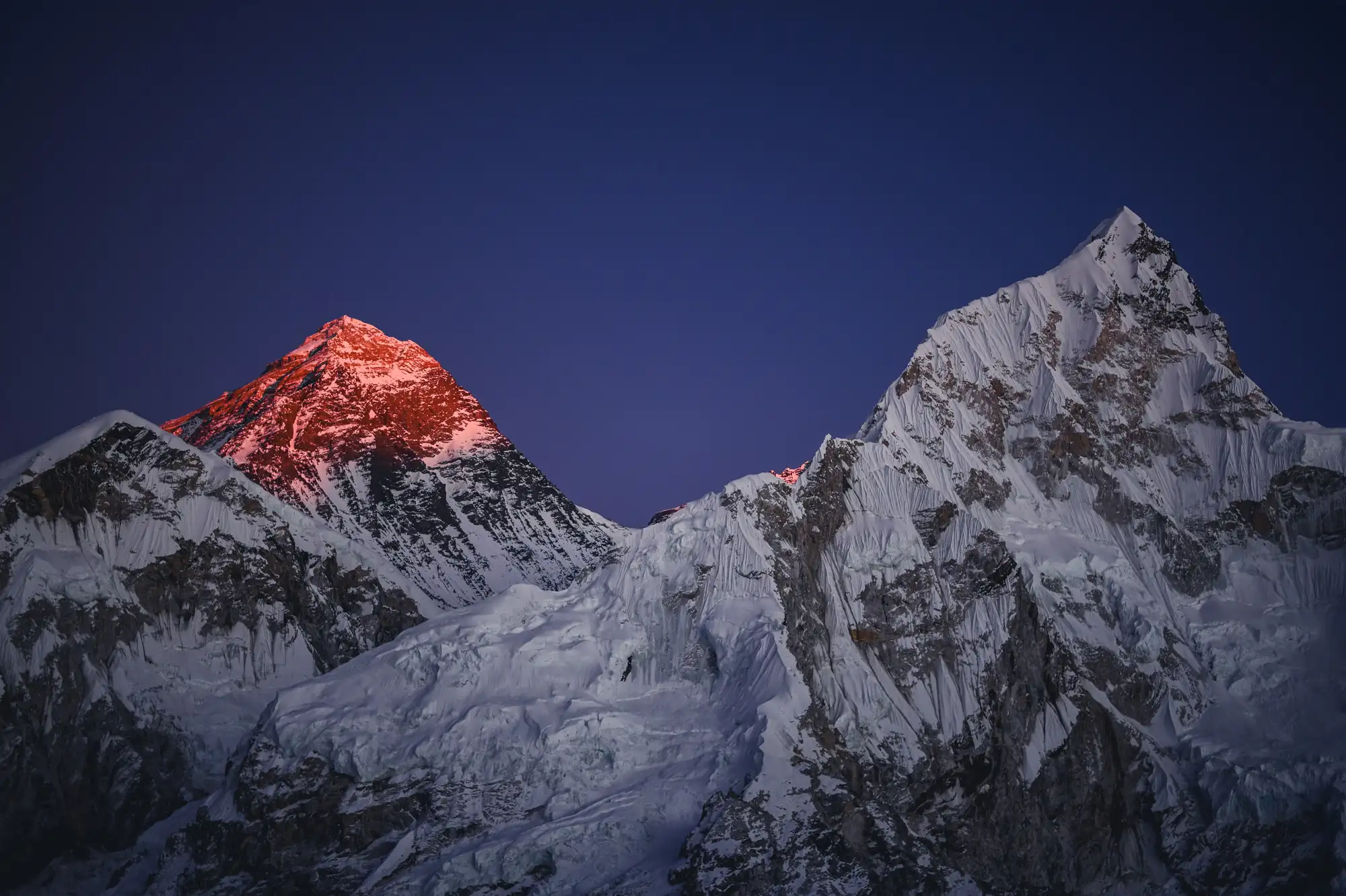 Snow-covered mountain at sunset